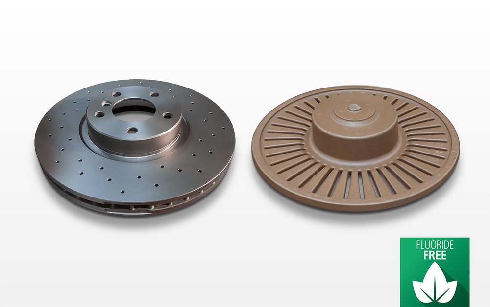 Two break disks, one metallic with perforations, and the associated core with a brown coating labeled as formaldehyde-free.