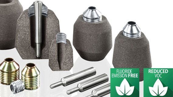 Assortment of Foseco foundry feeder sleeves and pins with labels indicating fluoride emission-free and reduced VOC properties.