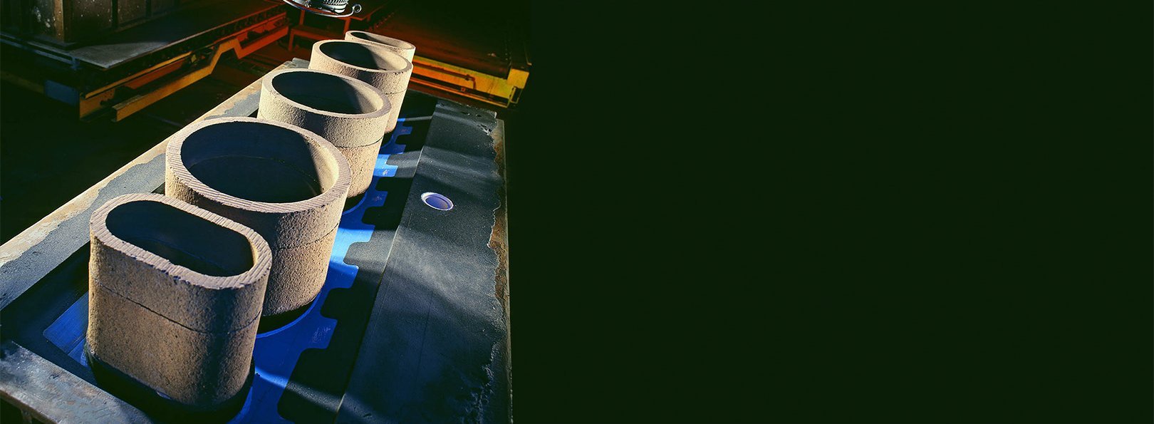 Three insulating feeder sleeves placed on a steel casting